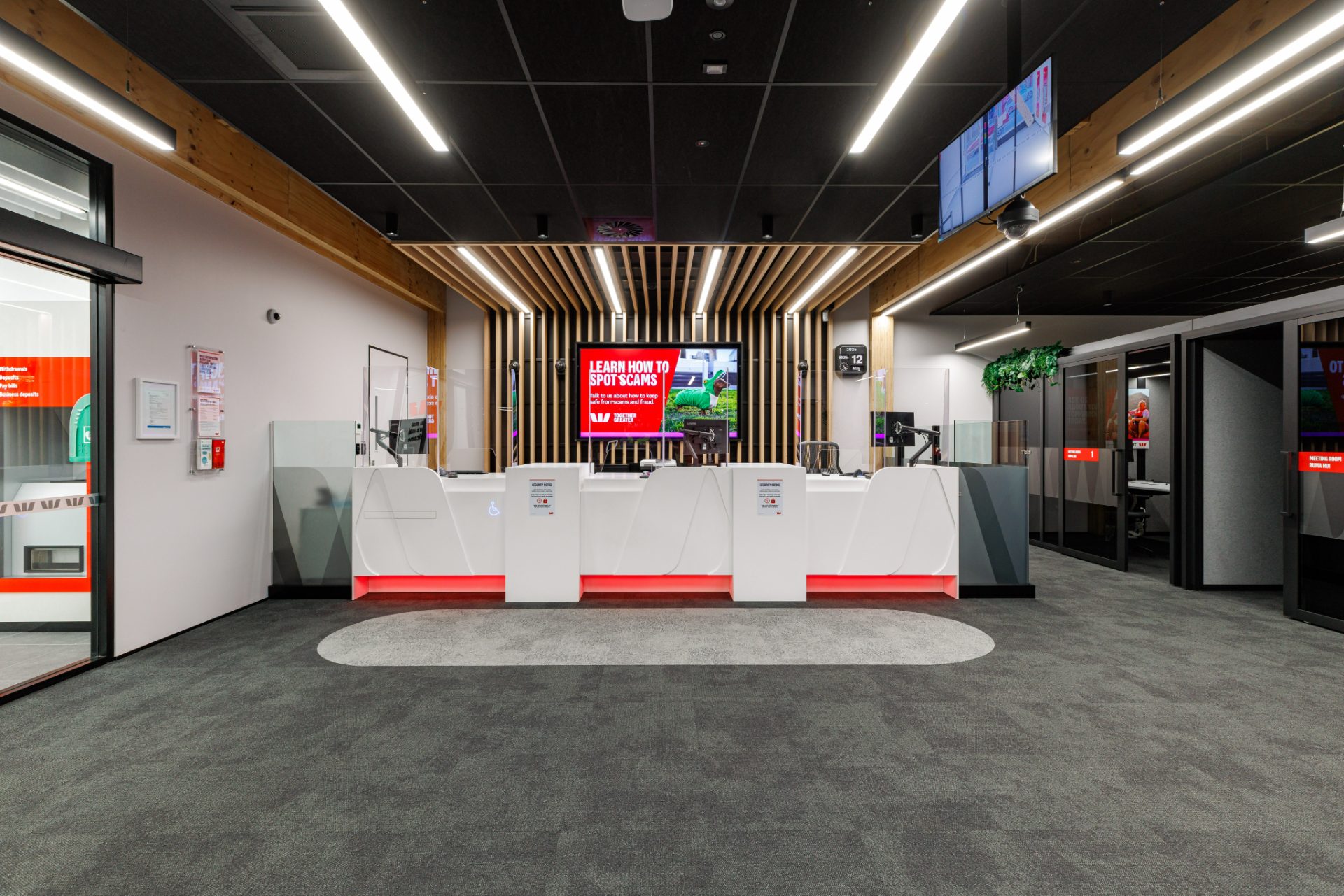 Lounge with red brand feature wall